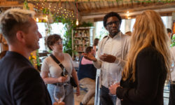 People stand around chatting whilst drinking Cote du rhone white wine at Shoreditch Treehouse